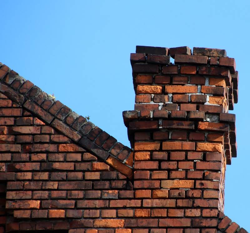 Signs Your Chelmsford Home Needs a Chimney Inspection Damaged chimney on an Chelmsford home showing cracks and missing mortar
